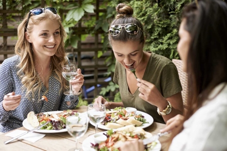 women laughing and eating