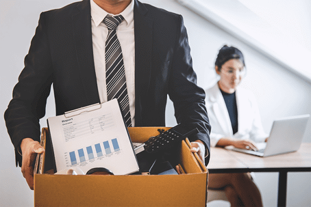 man with box of things from desk