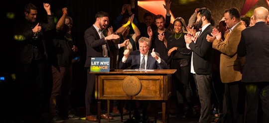 man with thumbs up surrounded by other men