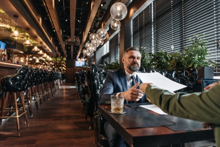 men discussing paperwork