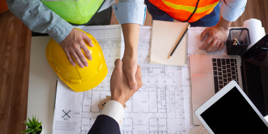 Construction workers shaking hands