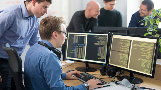 men looking at data on a computer
