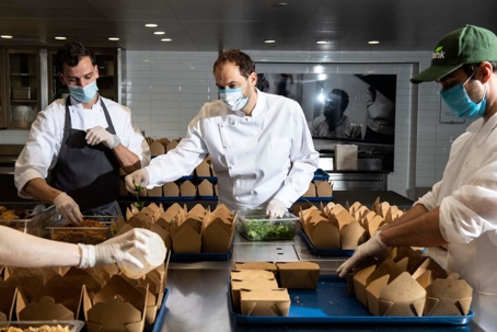 men packaging up food