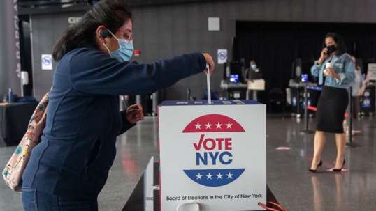 woman putting vote in box