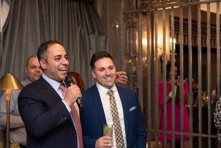 two men standing giving a speech