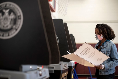 woman with face mask looking over documents