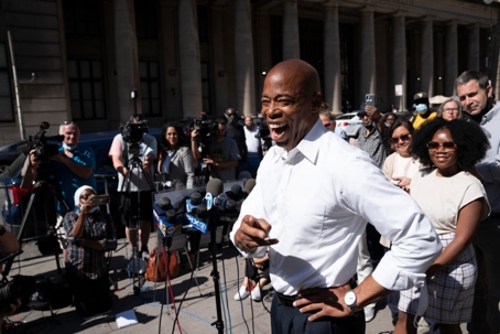 man smiling walking in crowd