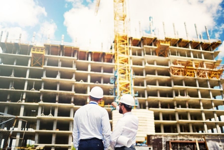 men in hard hats looking at construction