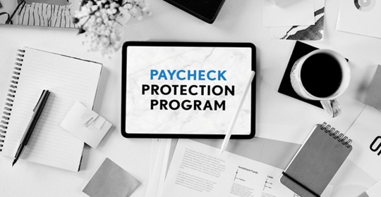 paycheck program on tablet with papers